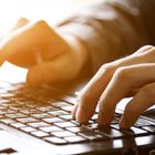 Mature hands working at keyboard