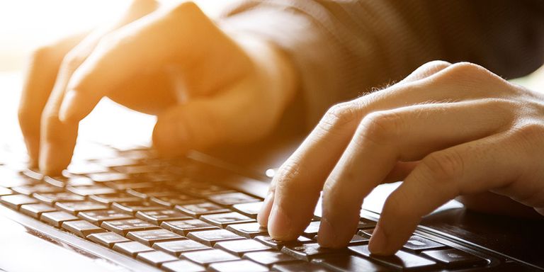 Mature hands working at keyboard